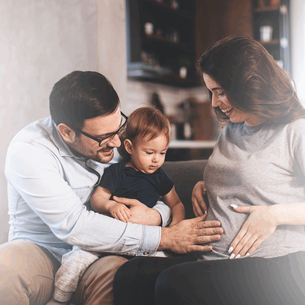 Familia sintiendo los movimientos del bebé durante el embarazo.